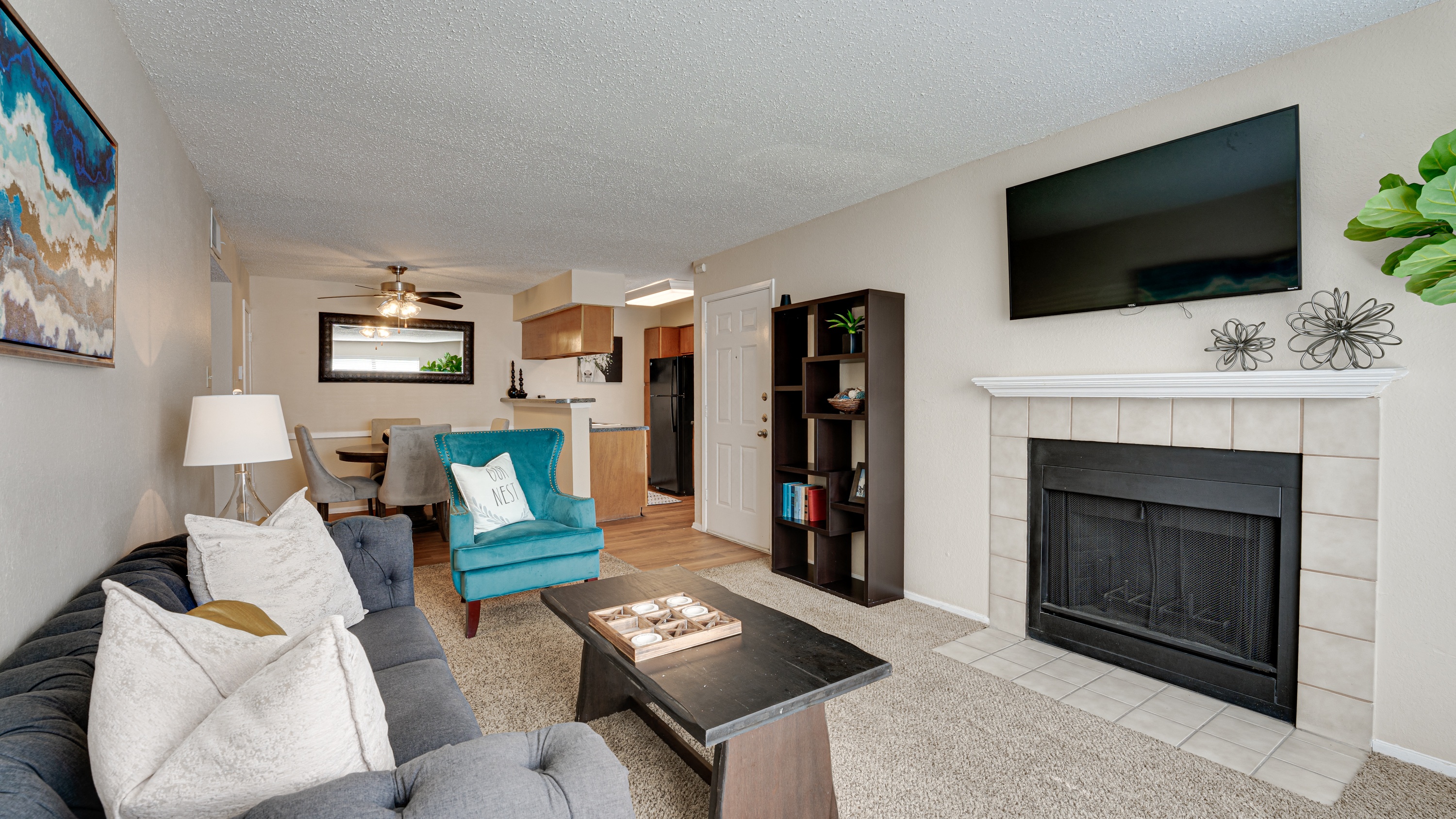 a living room with a fireplace and a couch and a table